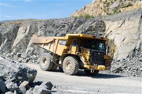 Douglassville Quarry: A Caterpillar 775G arrives on a bench to be loaded with shot rock.