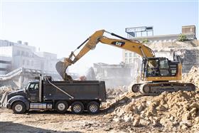 Structures Division: A Structures Division excavator loads export material into a triaxle dump truck. 