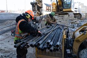 Structures Division: Two Structures Division team members prepare anchors for drilling.