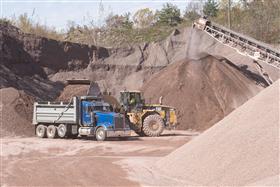 Pikes Creek Quarry & Asphalt: A Caterpillar 980G loads a dump truck with aggregate.