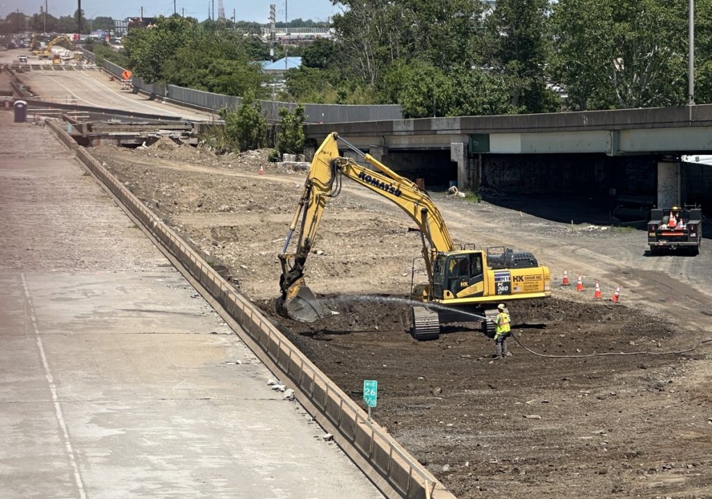 Excavator working in the cleared northbound I-95 construction area