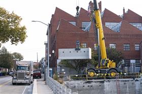 Structures Division: A crew places precast wall sections. 