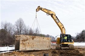 Pottstown Division: A Caterpillar 335F prepares to set a trench box for a pipe crew. 