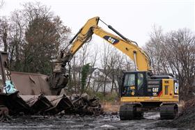 Haines & Kibblehouse, Inc.: A Caterpillar 335 excavator, equipped with a shear, cuts up rail cars for recycling. 