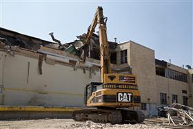 : A Caterpillar 345C works on demolishing a structure in Philadelphia, PA. 