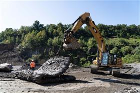 Pyramid Quarry: A Caterpillar 349F prepares to place blasting mats at Pyramid Quarry. 