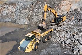 Pyramid Quarry: A Caterpillar 349F loads shot rock into a Komatsu HM400 truck down in the pit.