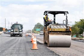 Haines & Kibblehouse, Inc.: A Caterpillar roller compacts stone on I-95.