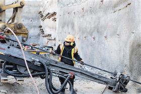 Structures Division: A Structures Division crew working on installing anchors along a shotcrete wall. 