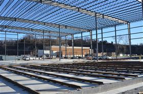 Easton Block & Supply: Easton Block & Supply's new steel structure stands with siding installation ongoing. 