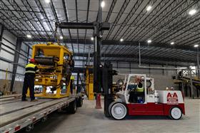 Easton Block & Supply: A new piece of machinery is unloaded from the trailer.