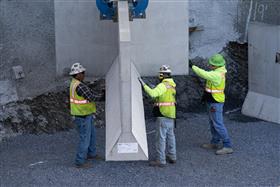 Structures Division: A Structures Division crew places a precast concrete wall. 