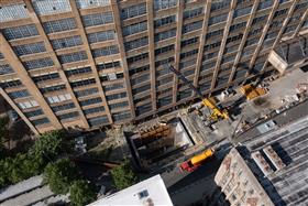 Haines & Kibblehouse, Inc.: A crew pours concrete via crane into a tight area.  
