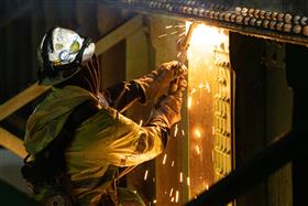 Structures Division: A Structures Division crew works on torching a bridge section for demolition. 