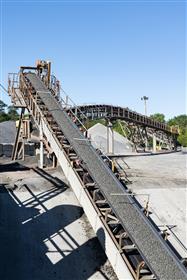 Dagsboro Stone Depot: A conveyor at Dagsboro Stone Depot showing stone coming out of a unloading hopper where rail cars are emptied. 