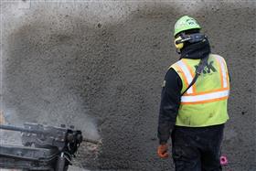 Structures Division: A Structures Division crew installs anchors along a shotcrete wall. 