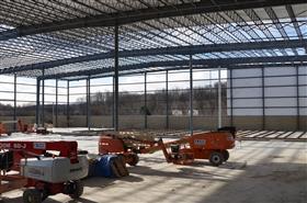 Easton Block & Supply: Easton Block & Supply's new steel structure stands with siding installation ongoing. 