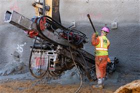 Structures Division: A Structures Division crew installs anchors along a shotcrete wall. 