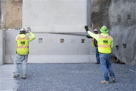 Structures Division: A Structures Division crew places precast concrete wall pieces. 