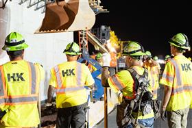 Structures Division: A Structures Division crew moves barrier on a highway project. 