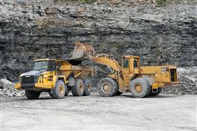 Hilltop Quarry: A Caterpillar 988F loads a Komatsu HM400 with shot rock.