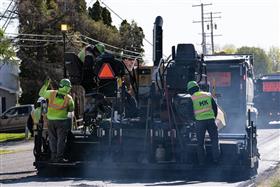 Landis C. Deck & Sons Division: A paving crew lays fresh blacktop down. 