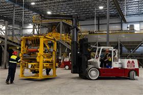 Easton Block & Supply: A new piece of machinery is moved into place inside the new plant. 