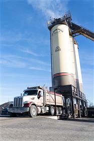 Delaware Valley Asphalt: A truck comes out from the silos after being loaded with asphalt. 