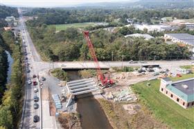 Structures Division: A Structures Division crew sets beams on the SR443 project. 