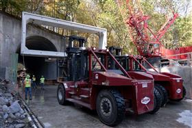 Structures Division: A Structures Division crew utilizes two large Taylor forklifts to move and place precast box culverts within a tunnel.