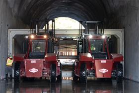 Structures Division: A Structures Division crew utilizes two large Taylor forklifts to move and place precast concrete box culverts in a tunnel. 