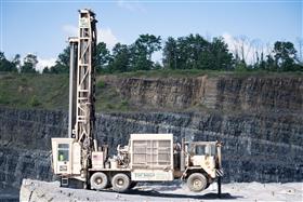 Drilling Division: A drill works on a upper bench at Naceville Quarry. 