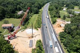 Structures Division: A Structures Division utilizes a crane to pile drive beams into the ground.